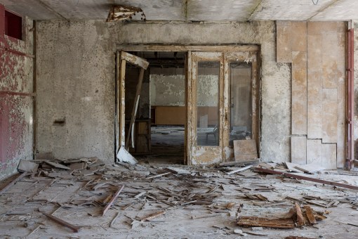 Lobby of Hotel Polissia. The check-in desk is in the background. Marble wall cladding has been removed by looters.