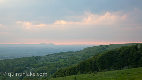 Cleeve common hill at dusk near Cheltenham, Malvern Hills in the distance, Gloucestershire, England