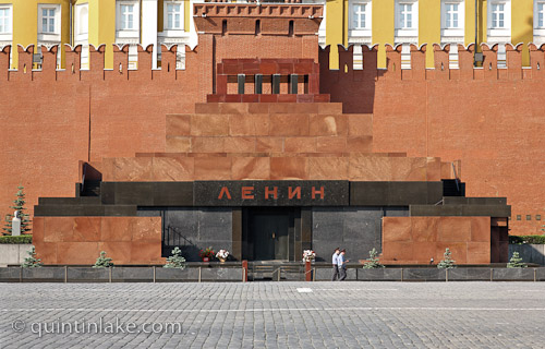 Two policemen walk past the Facade of Lenin's Mausoleum, Red Square, Russia