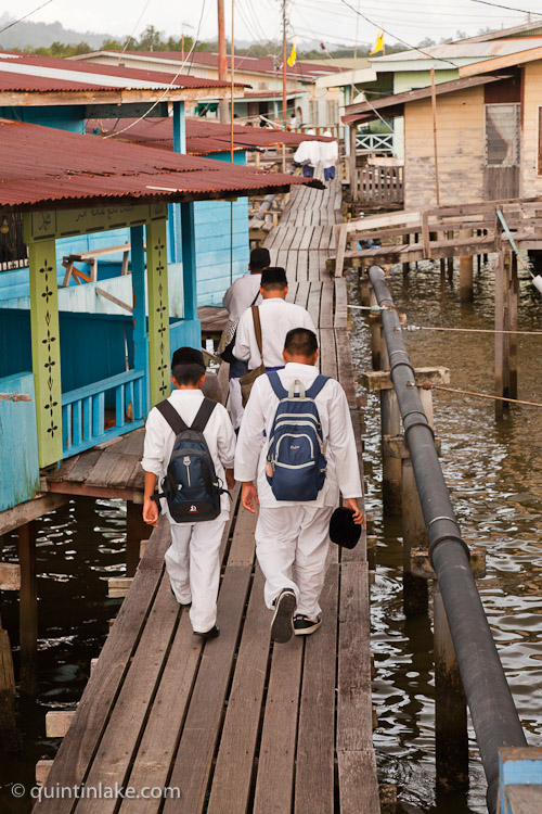Muslim schoolboys wearing songkok (malay hats) returning home in the Kampung Ayer (Water village), Bandar Seri Begawan (BSB), Brunei