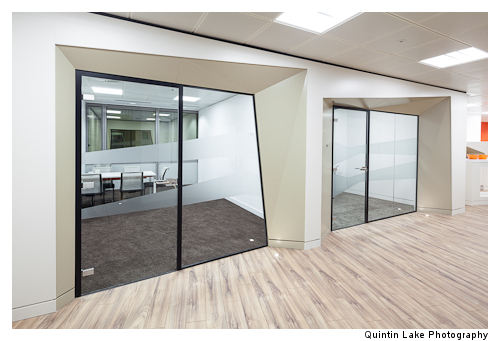 Faceted meeting rooms help break down the standard cellular feeling of such spaces