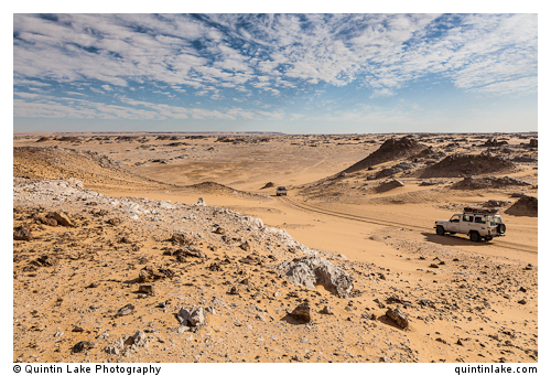Landcruisers descend into a wadi in the Sahara Suda (Black Desert), Egypt