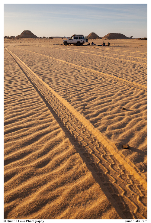 4X4 tracks in the sand and camp in the Western Desert, Egypt