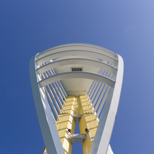 Spinnaker Tower being painted gold for rebranding as Emirates Spinnaker Tower. The 170 meter structure was designed by HGP Architects and built in 2005. Portsmouth, Hampshire.