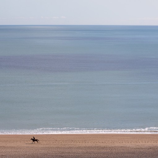 Horse rider on Slapton Sands, Devon.
