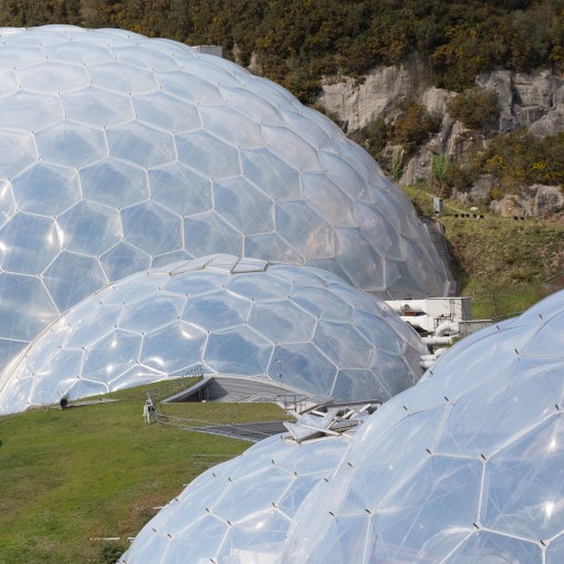 Biomes and grass roofed link building, Eden Project, Cornwall.