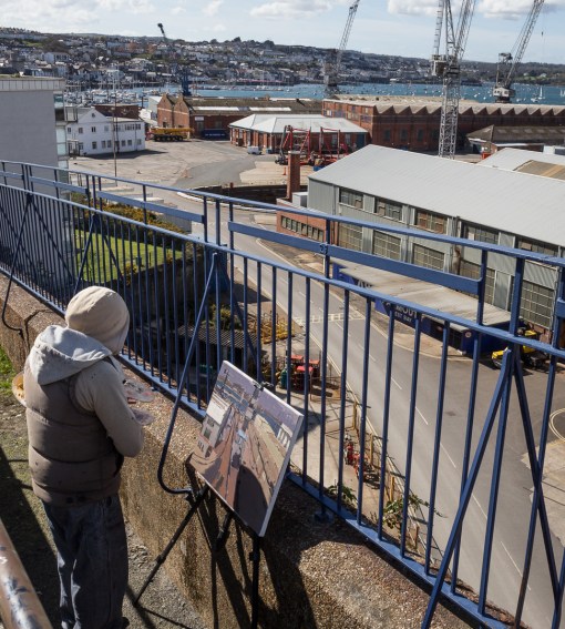 Artist Ben Taffinder painting at Falmouth Docks, Cornwall.