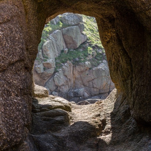 Porthgwarra, manmade tunnel leading to the historic site of tidal ‘hulleys’, wooden containers used for storing shellfish. Cornwall.
