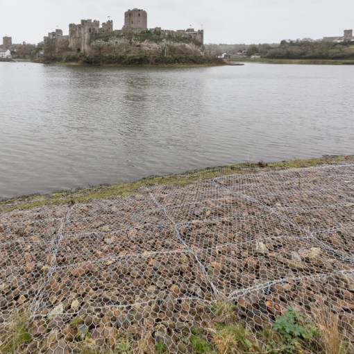 Defences. Contemporary gabion revetments &amp; Pembroke Castle built in 1093, Pembrokeshire.